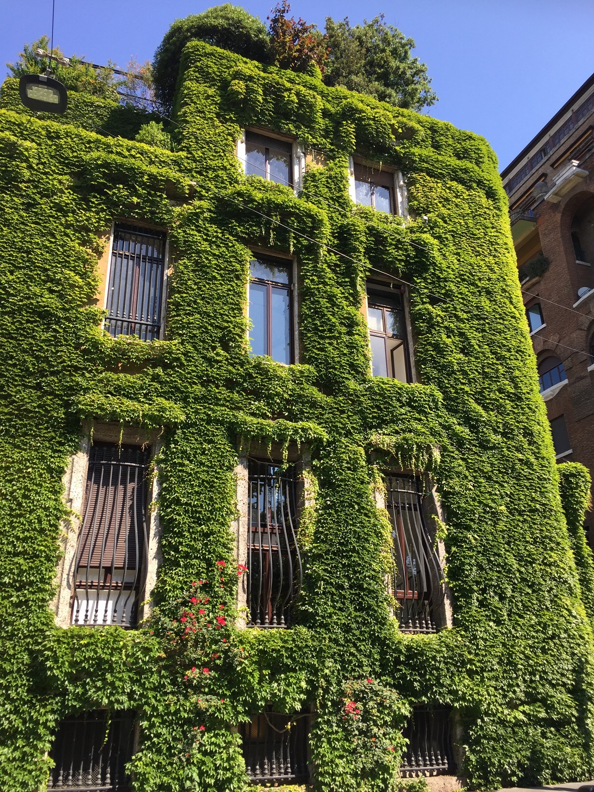 multi level building covered in greenery called villa mozart in milan